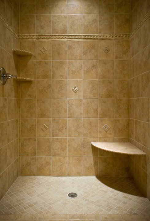 Tiled shower with decorative accent tiles and built-in bench
