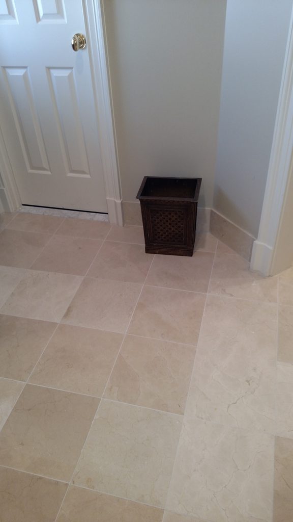 Natural stone tile floor detail near a hallway doorway
